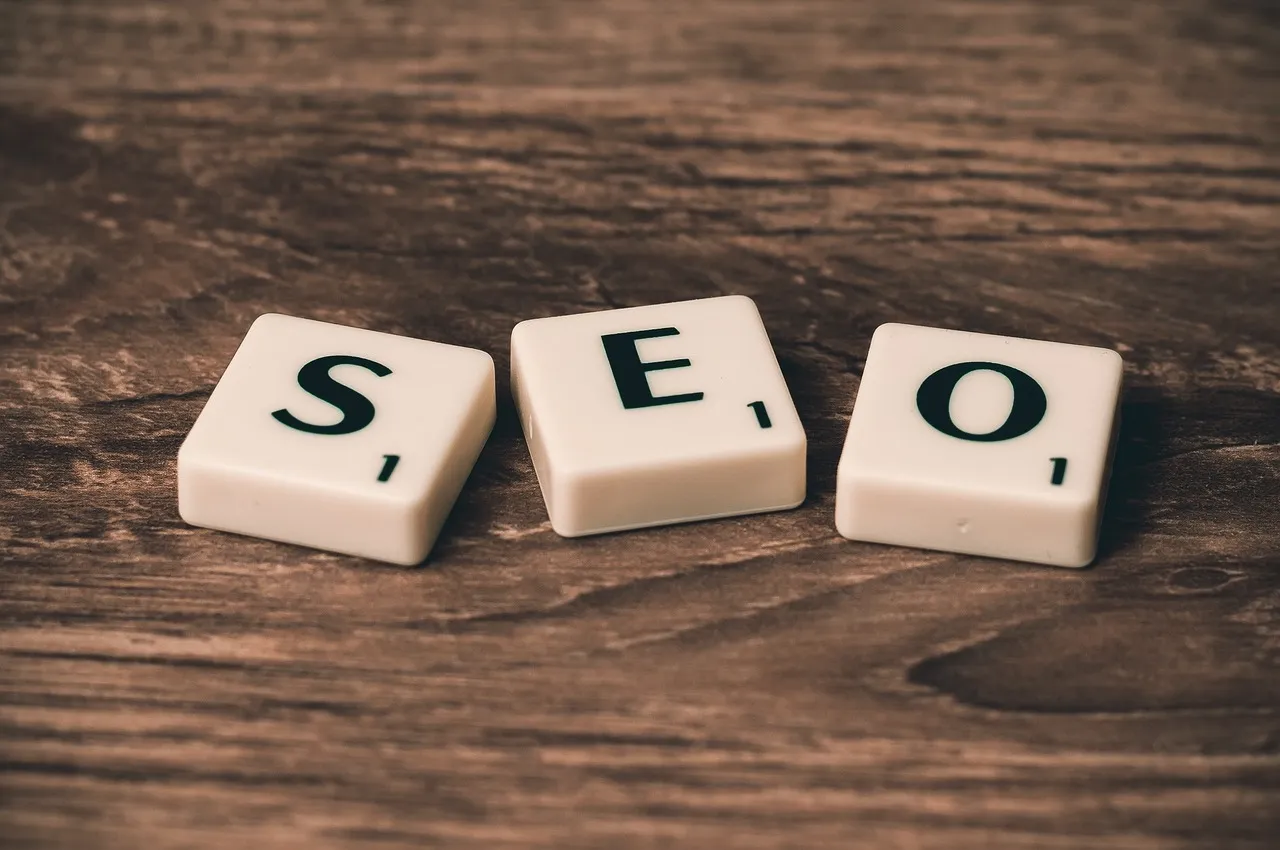 Scrabble tiles spelling 'SEO' on a wooden surface, representing SEO image optimization for better search visibility