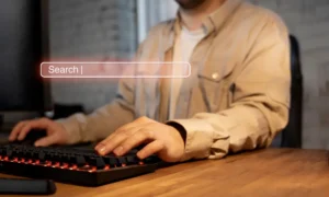vA man typing on a keyboard, focused on finding a zero search volume keyword for SEO optimization.